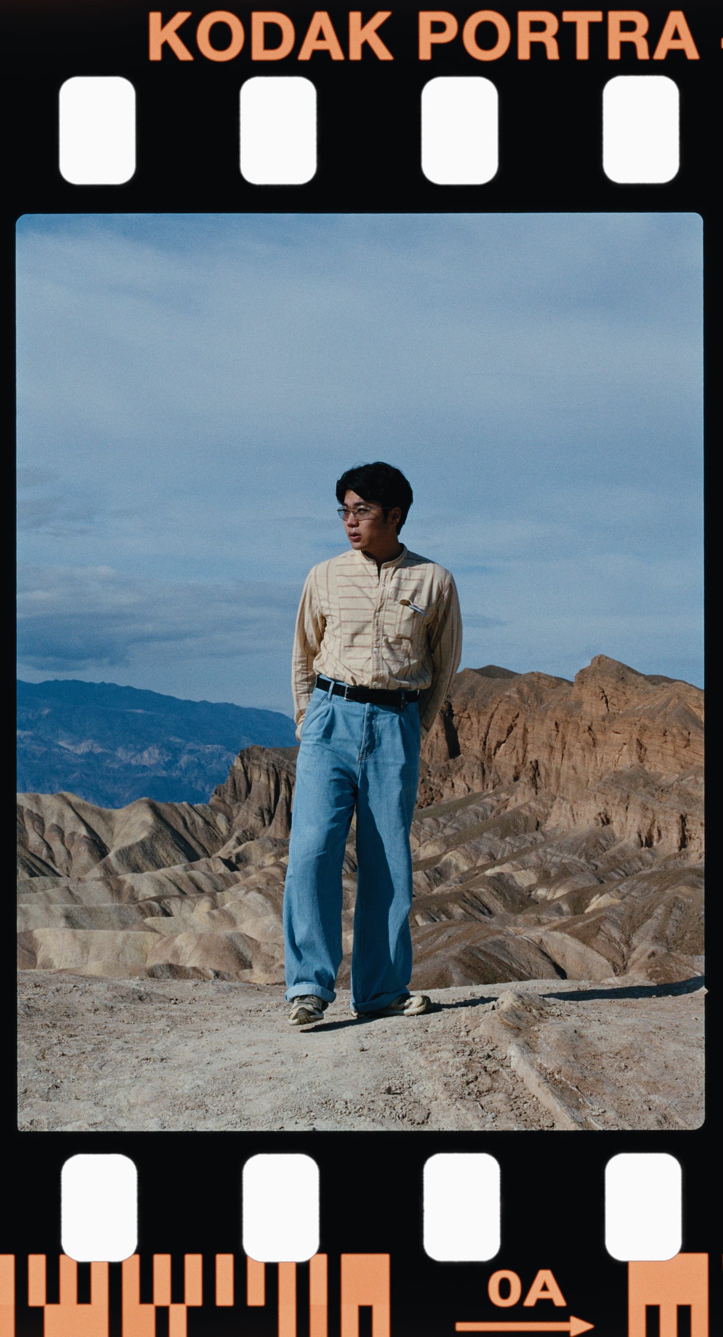 A man standing in the badlands, Kodak Portra 160 on a 135 half frame.